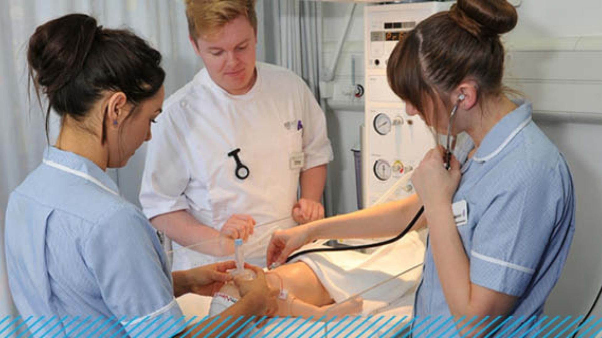 Three Child Nursing students stood around a young child (dummy) on a hospital bed